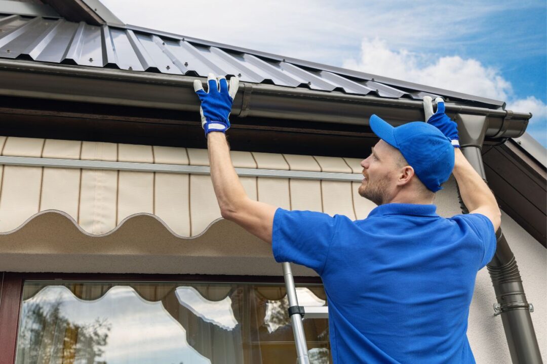 repair man working on gutters