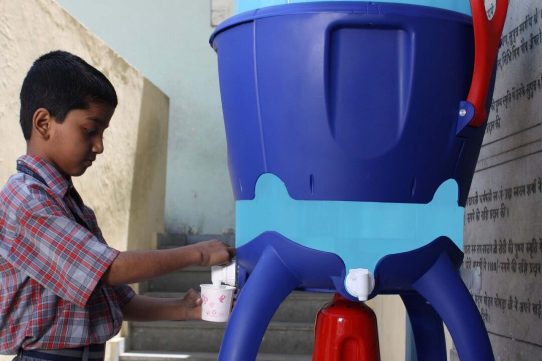 kid drinking from lifestraw